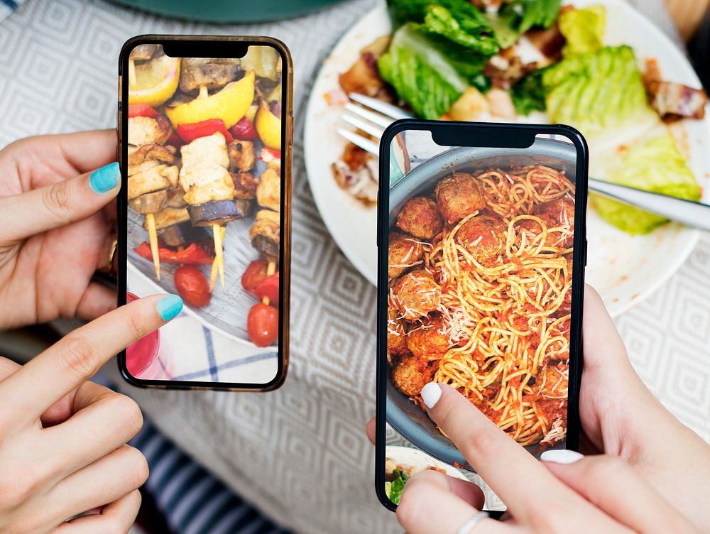 People sharing food photos on mobile phone