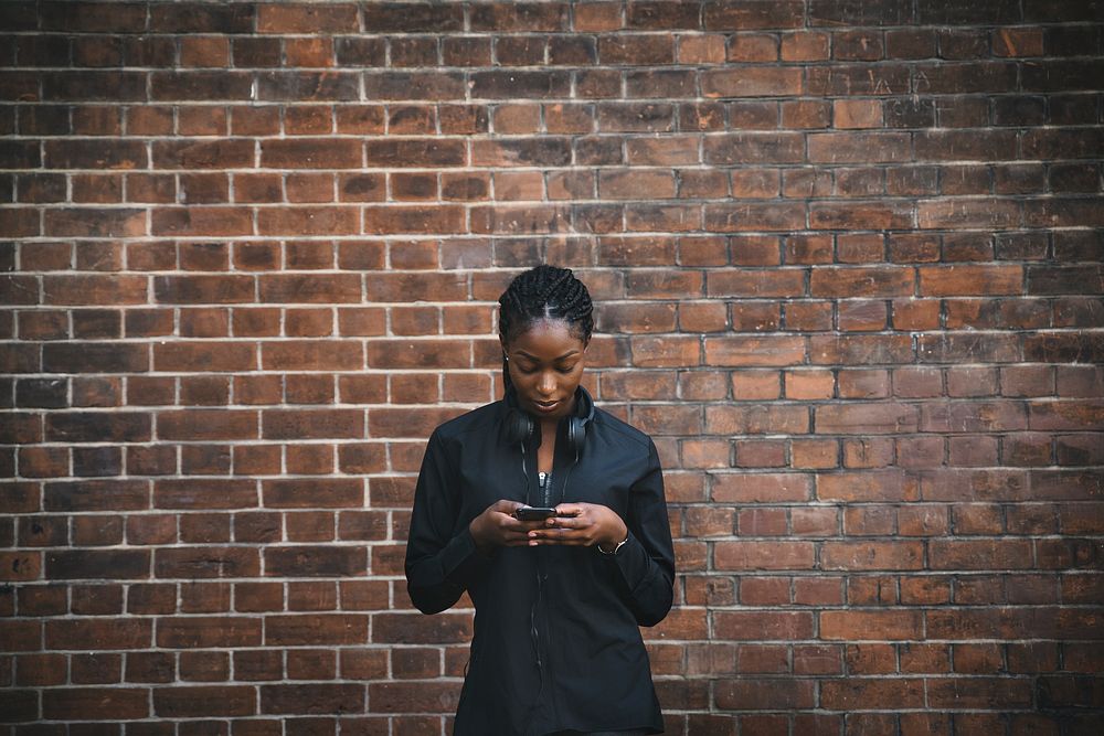 Black woman texting on smartphone