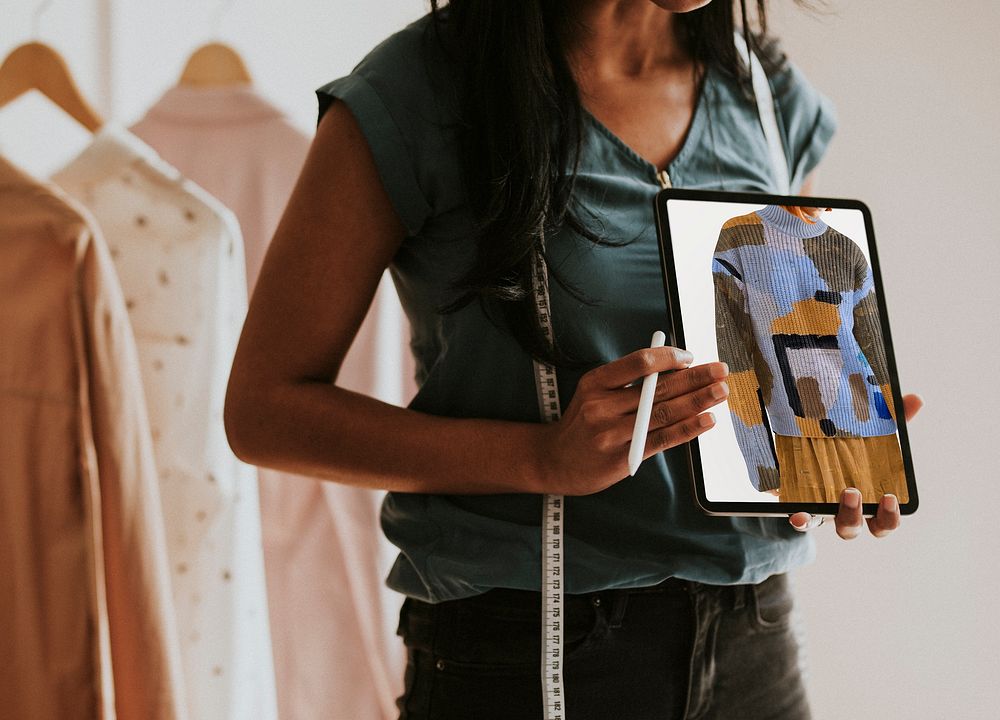 Fashion designer holding digital tablet photo