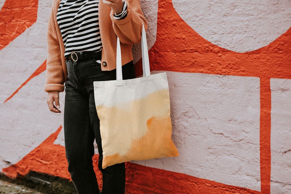 Woman using orange tote bag 