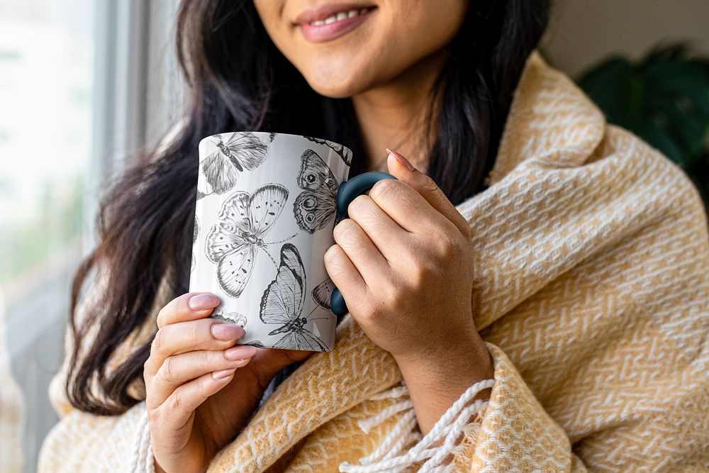 Woman holding butterfly coffee mug