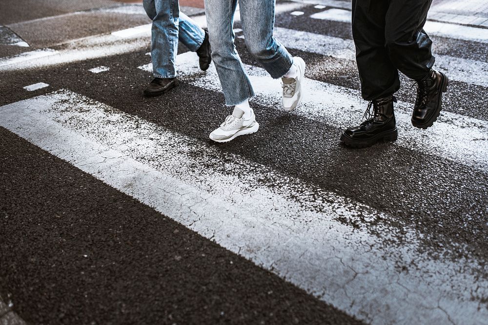 People wearing sneakers, crossing road