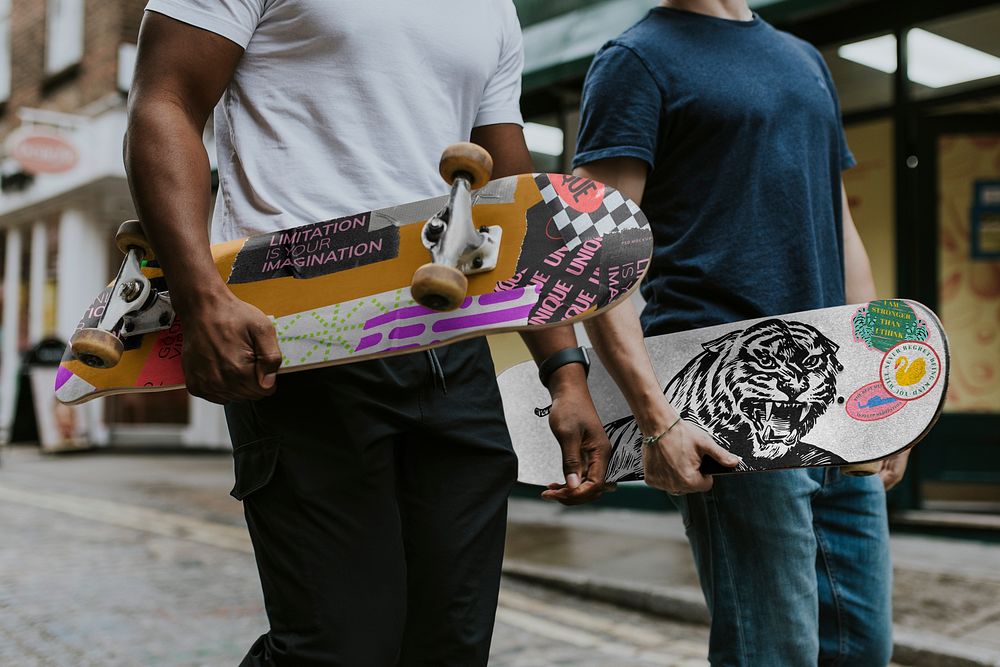 Men holding skateboards on street