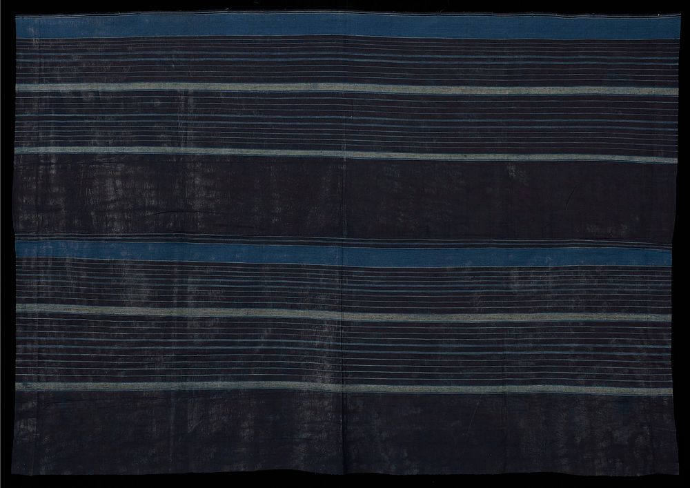 blue textile with light blue and grey stripes; stripes vary in width; short edges of textile hemmed; textile constructed of…