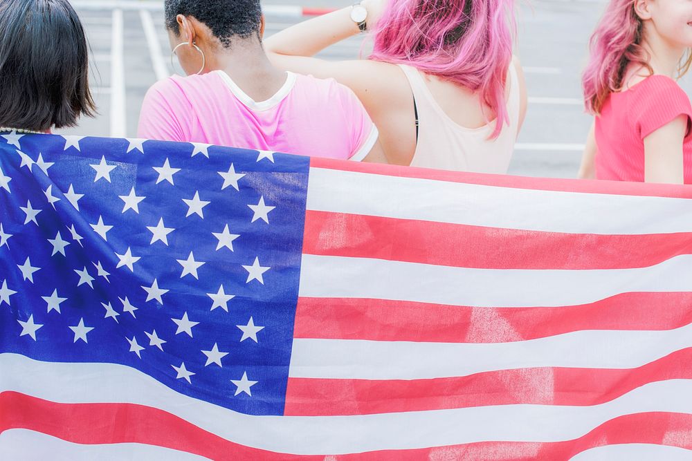 American flag with women wearing pink