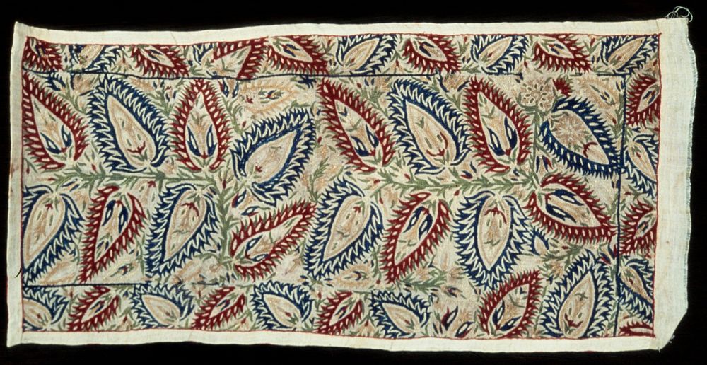 Linen strip, with a design of geometrical flowers and leaves embroidered in blue, red, green, and yellow silks in…