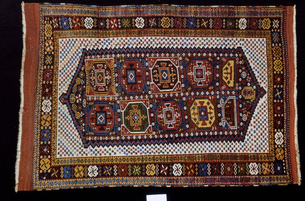 Hearth rug, Yomud type. A white field sewn with small stars (?) ('checkerboard') contains a badly designed hexagonal…