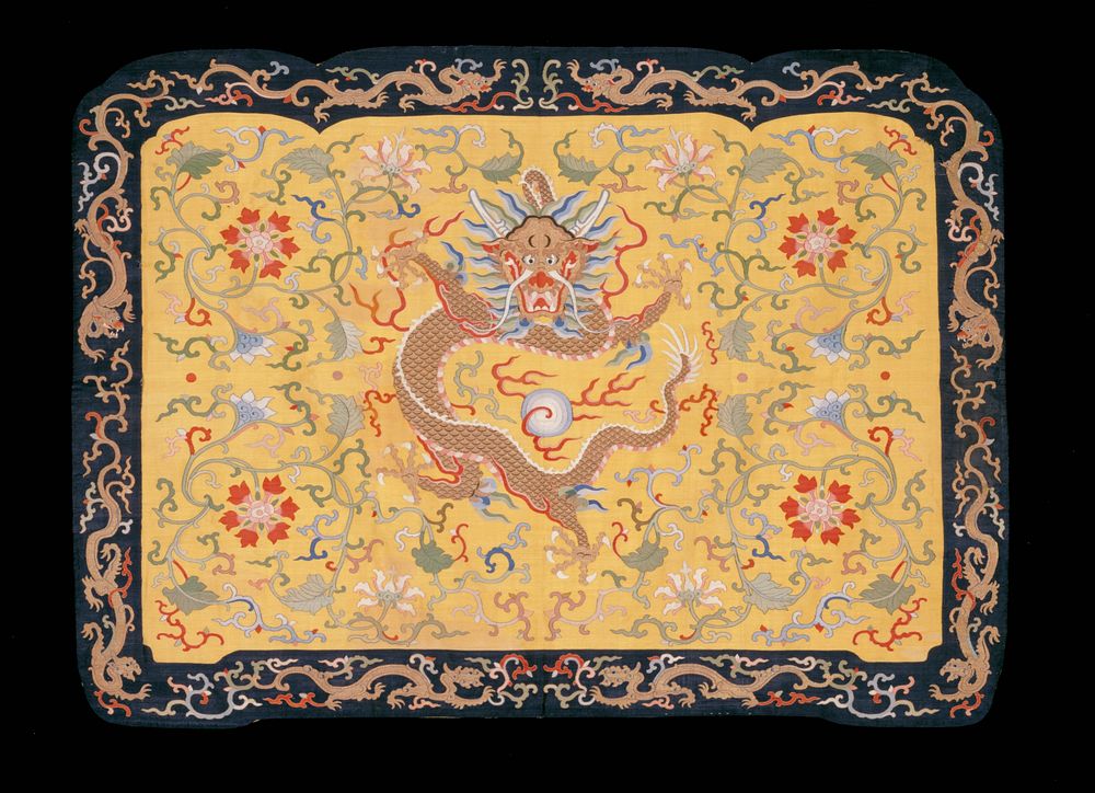 Panel of imperial yellow k'ossu. In the center, a large five-clawed dragon in gold surrounded by large red blossoms with…