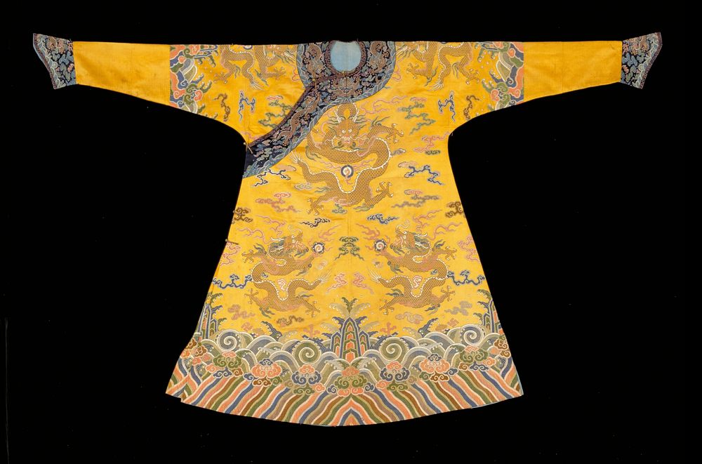 Imperial robe of yellow satin brocaded in green, rose, blue, brown, black, red, orange, and gold. Nine 5-clawed dragons…