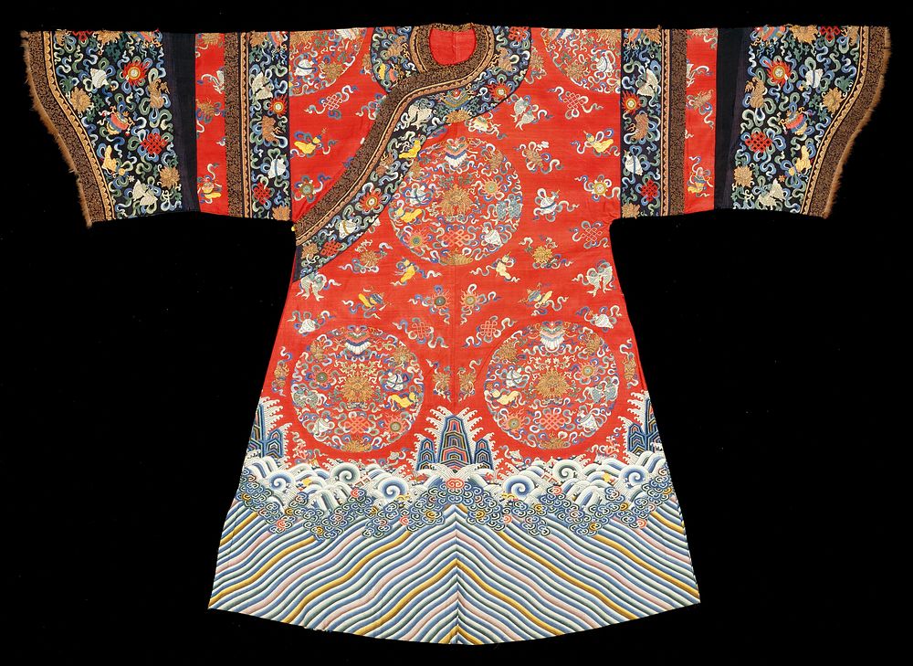 Robe of cherry red kesi with six large medallions on body and half-medallions on shoulders, containing the eight Buddhist…