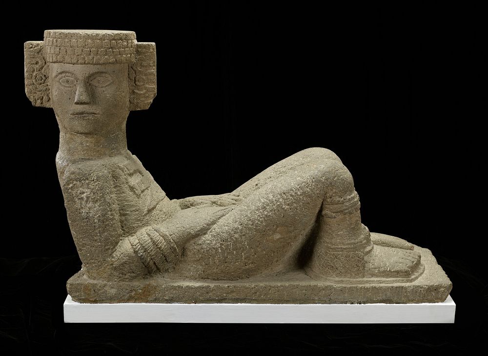 Sculpture determined to be a copy of a work from Chichen Itza, Yucatan Peninsula. Reclining figure resting on elbows, head…