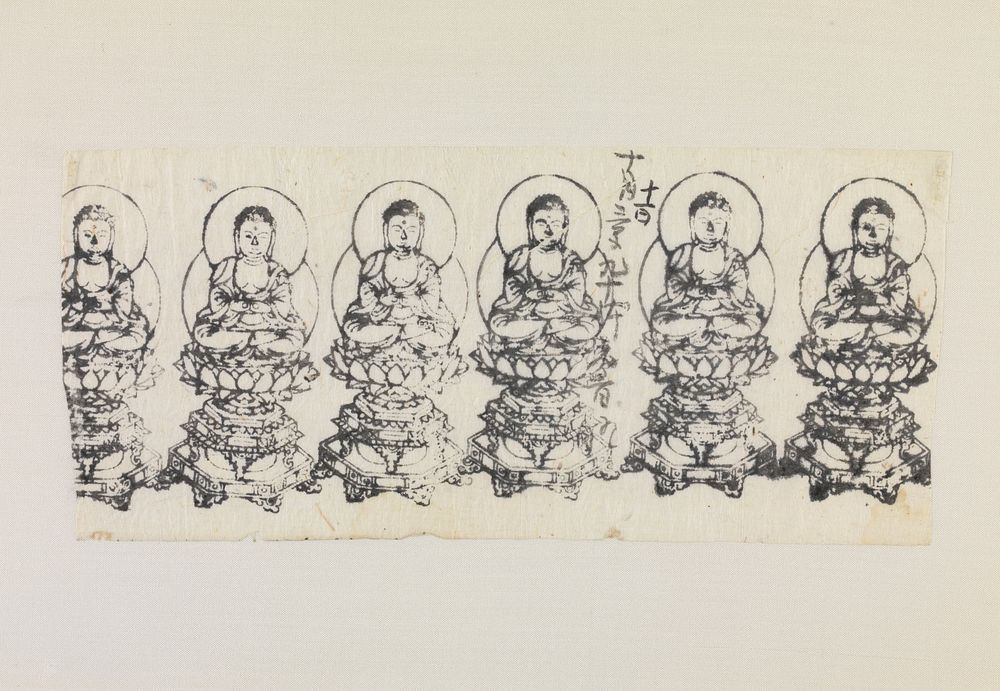 Framed: row of six seated Buddha figures; sitting cross-legged on lotus pedestal; double behind body; light inscription near…