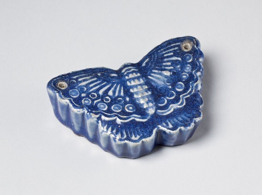 Blue butterfly shaped porcelain water dropper; two small holes, one at the tip of each wing. Original from the Minneapolis…