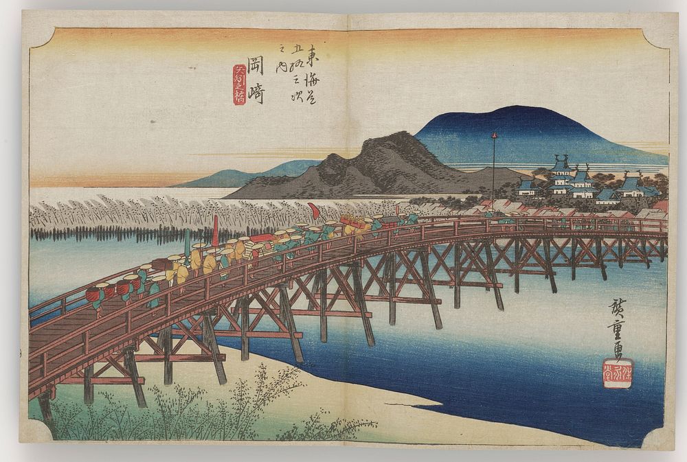 distant view of procession crossing long bridge over river; blue and black mountains, and a distant castle in background.…