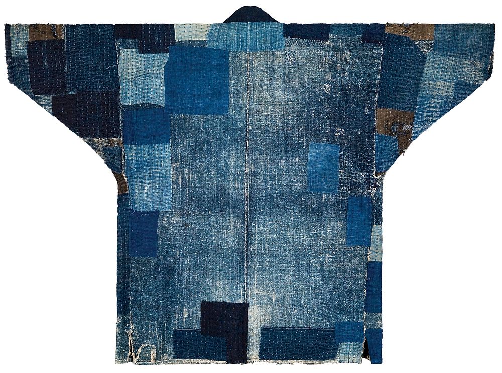 Thick, cotton patchwork coat with various shades of blue and brown patches; dark blue band of fabric at opening. Original…