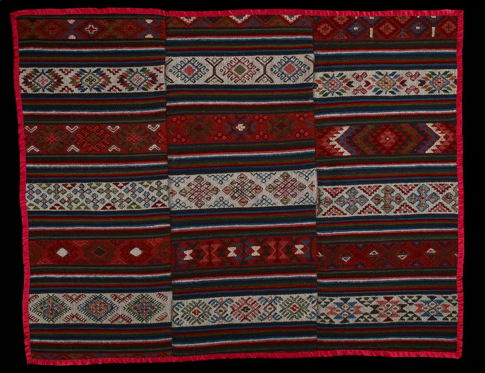 six bands of stripes alternating with six patterned bands (three on white ground, three on red ground); red ribbon trim;…