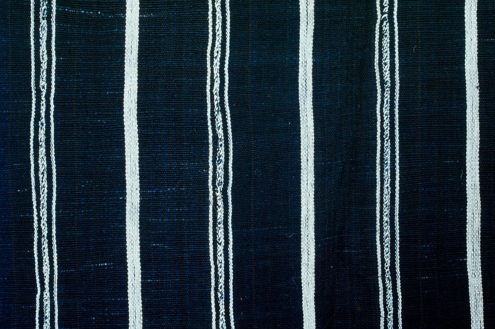 indigo ground; single white stripes alternating with double thin stripes on either side of seam; nine panels; two short ends…