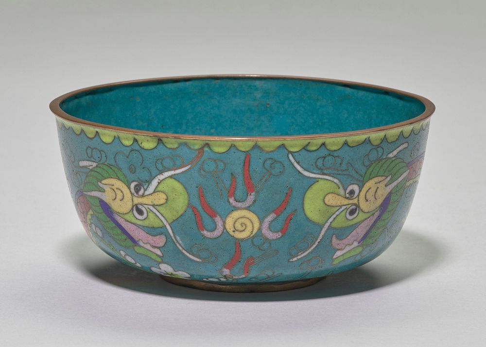 Cloisonne bowl; gold rim and base, blue interior; exterior, blue ground with green branch and flower patterns in background…