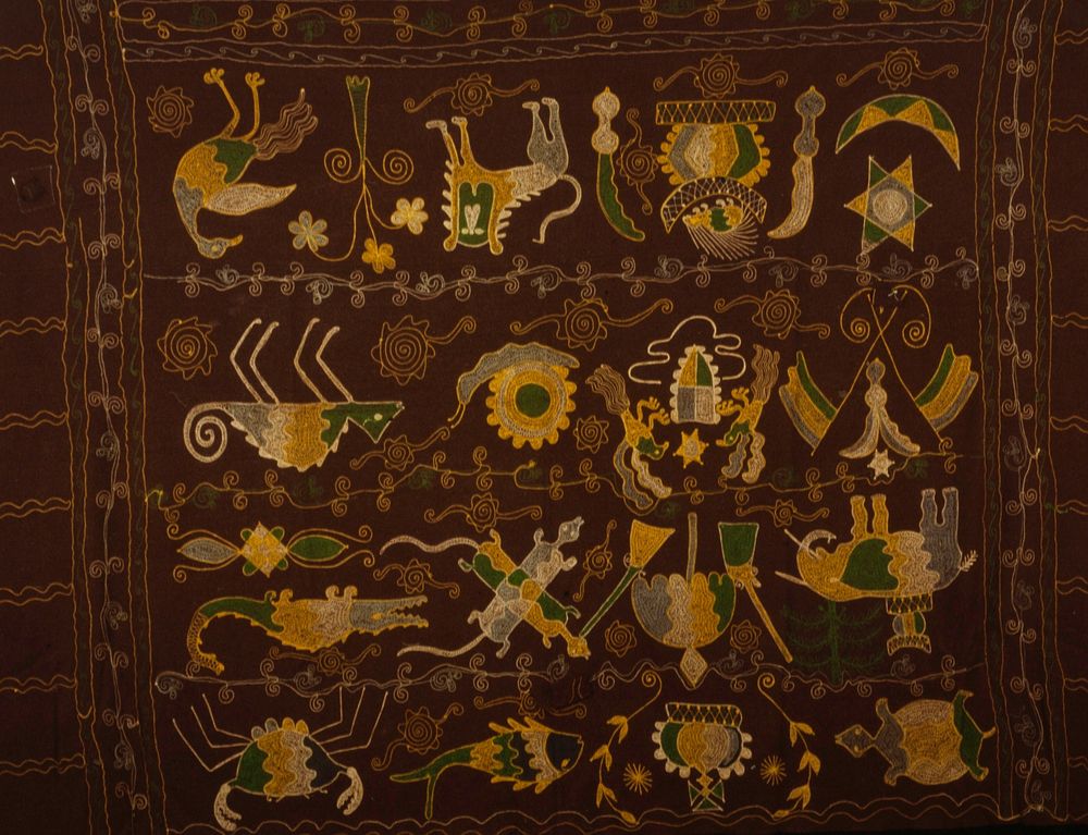 hanging, wool with multicolored chainstitch embroidery; motifs include lion, elephant, stool, swords, birds, crocodiles…