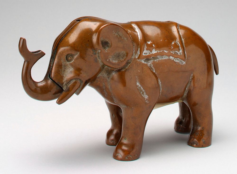 very heavy brass elephant; push tail, trunk moves up. Original from the Minneapolis Institute of Art.