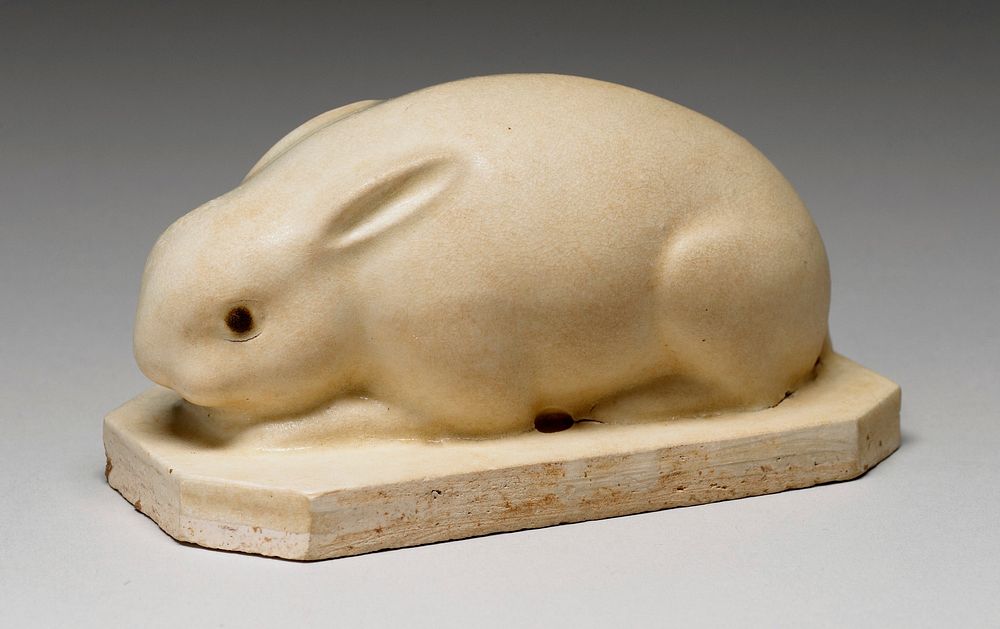 crouching rabbit with small ears and brown eyes; rectangular base with squared-off corners. Original from the Minneapolis…