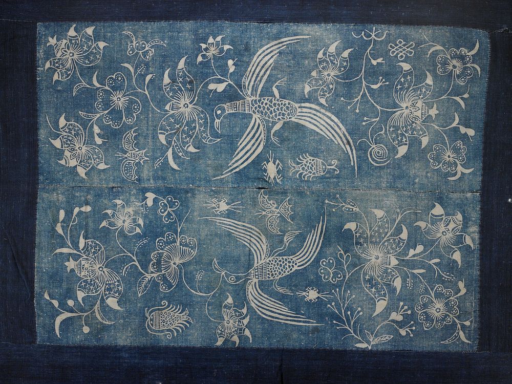 wide dark blue band surrounding lighter blue batik center in two panels; large floral, bird and insect patterns. Original…