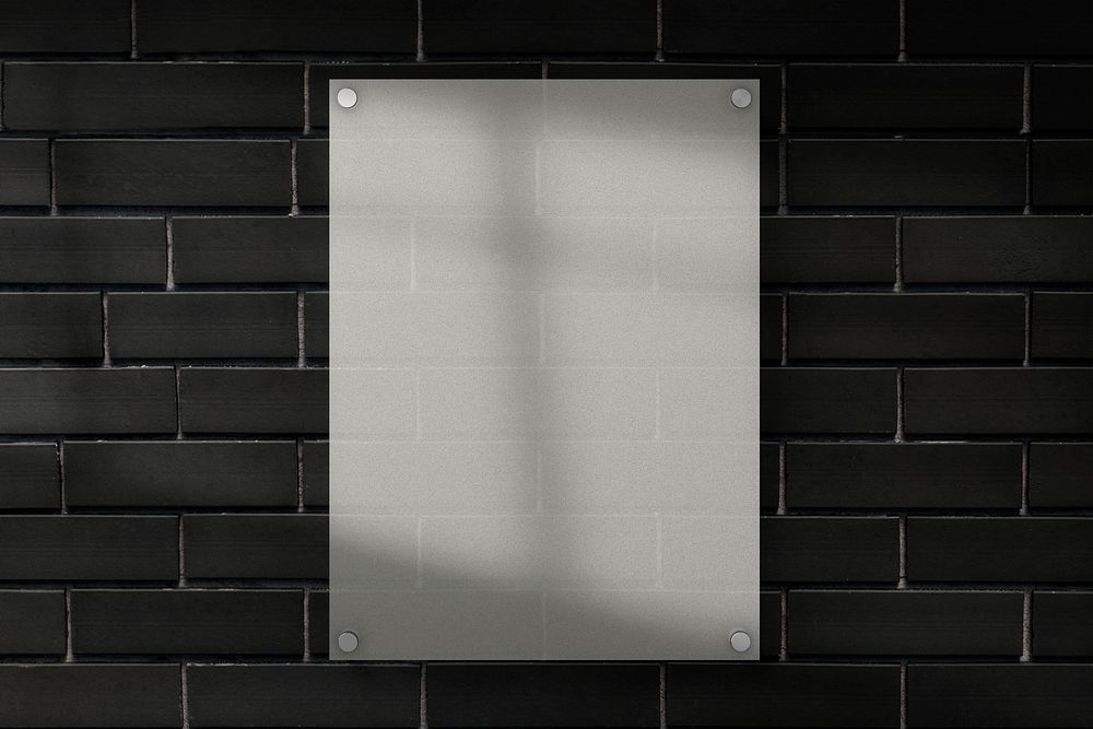Blank sign poster on a wall with window shadow