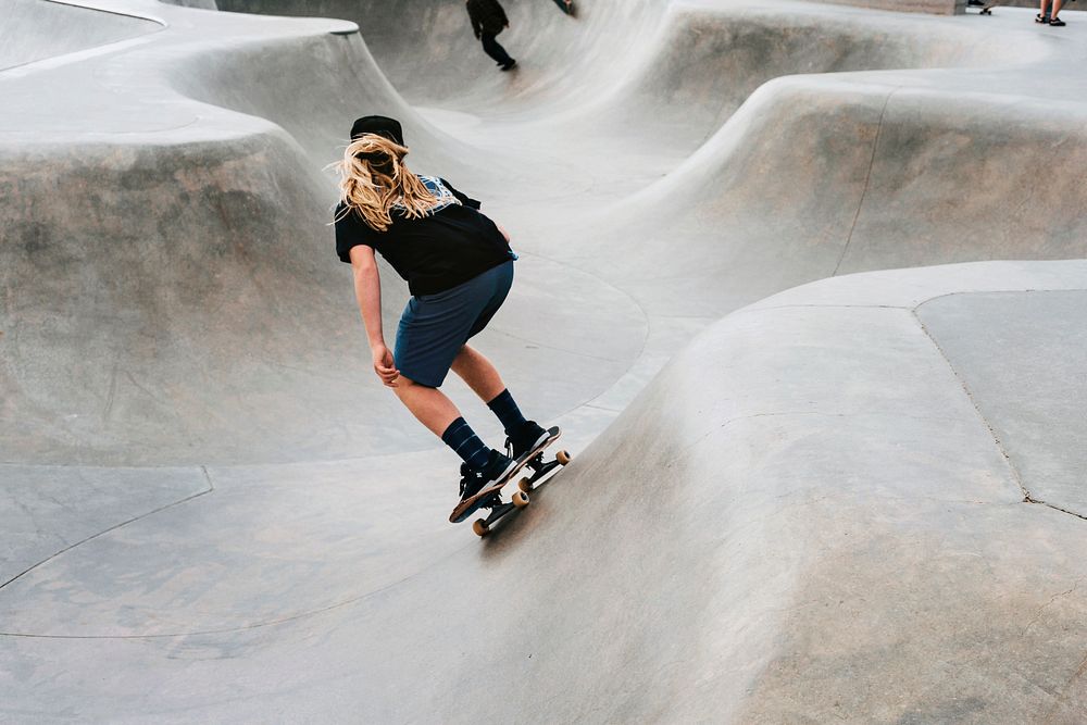 Blonde woman riding skateboard, hobby photo