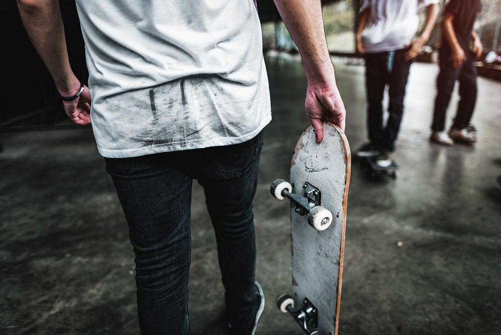 Man carrying skateboard, hobby, lifestyle photo