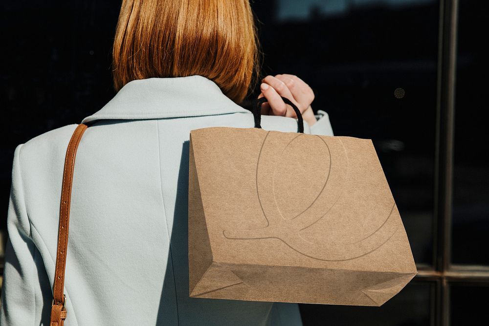 Shopaholic woman with a brown shopping bag