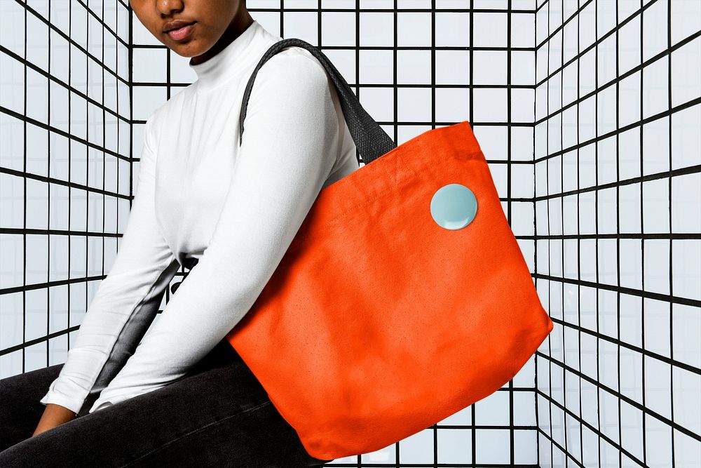 Woman using orange tote bag