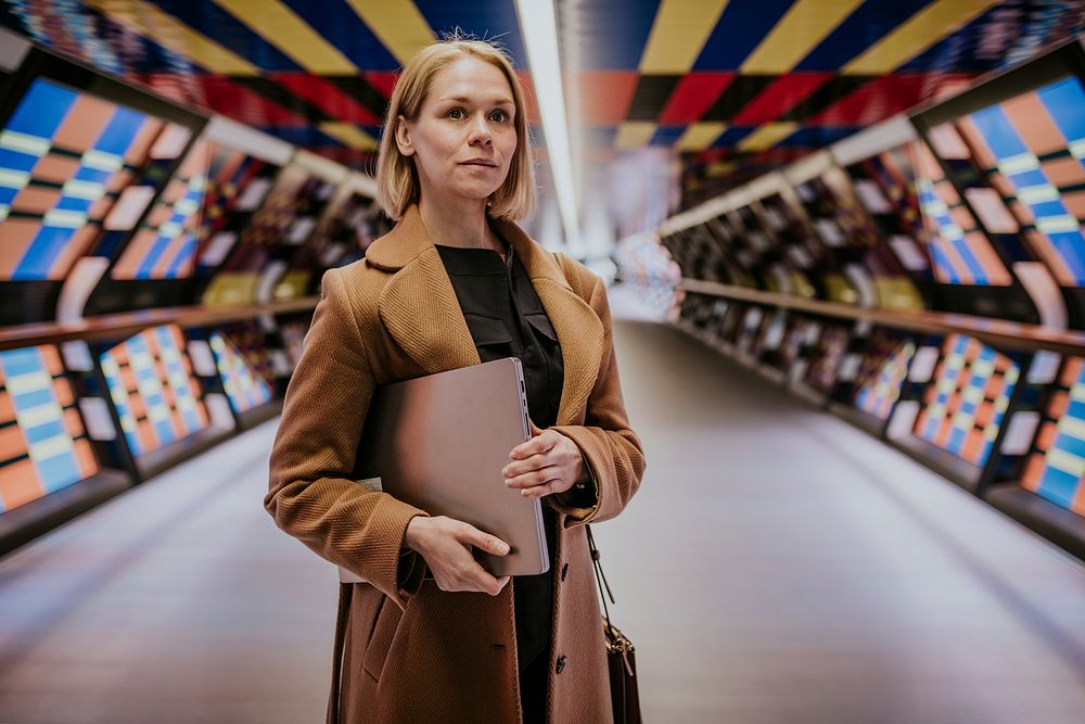 Businesswoman holding laptop, work essential