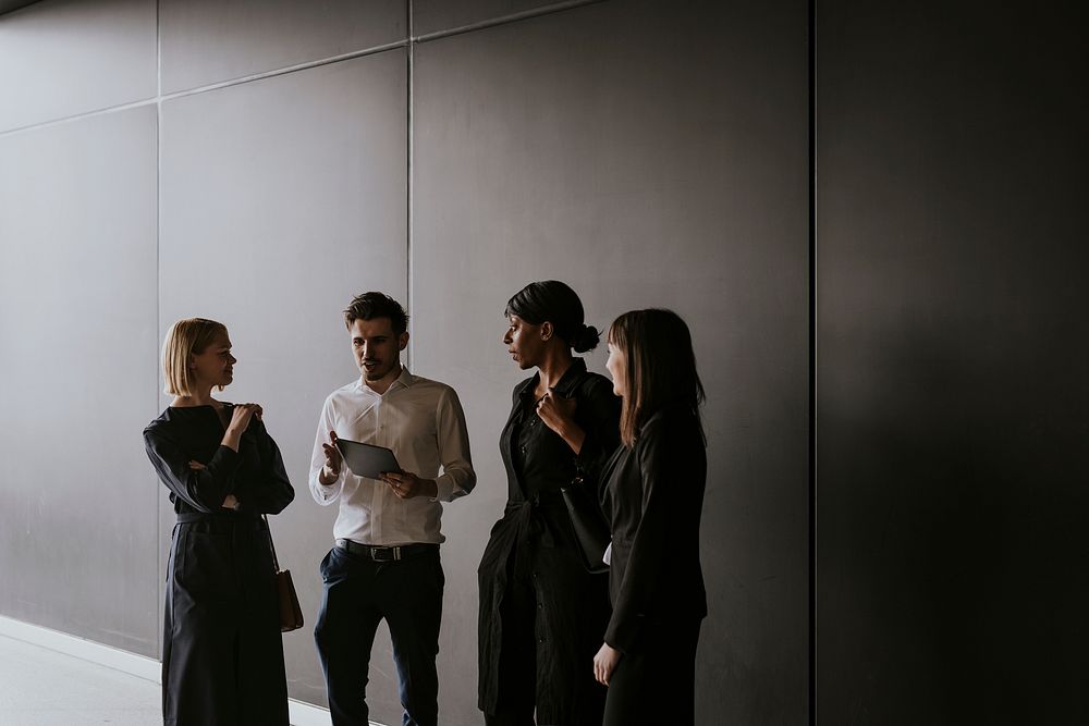 Business colleagues discussion, holding tablet