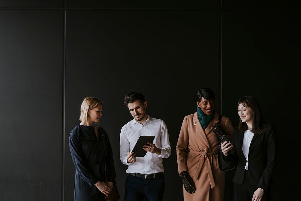 Business colleagues discussion, holding tablet