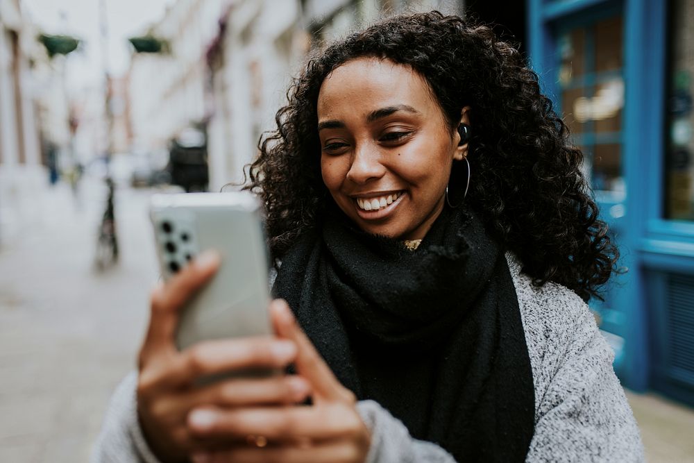 Happy woman video calling on her phone