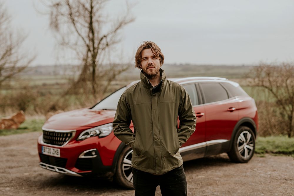 Man on road trip, standing with hands in pockets photo