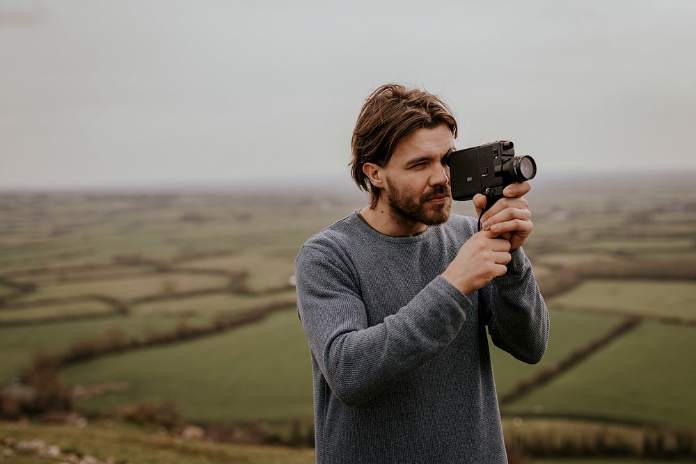 Man recording video with film camera