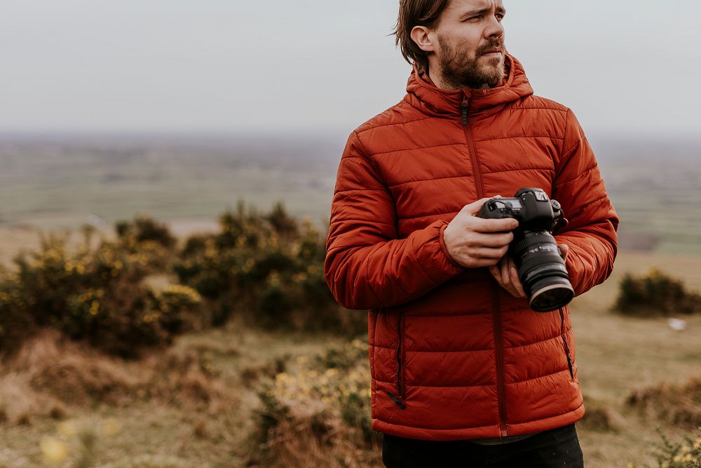 Photographer holding camera, nature photography