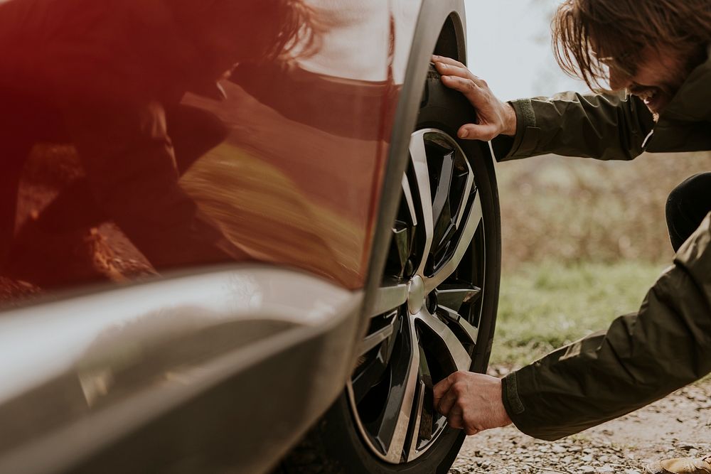 Man checking car tire photo