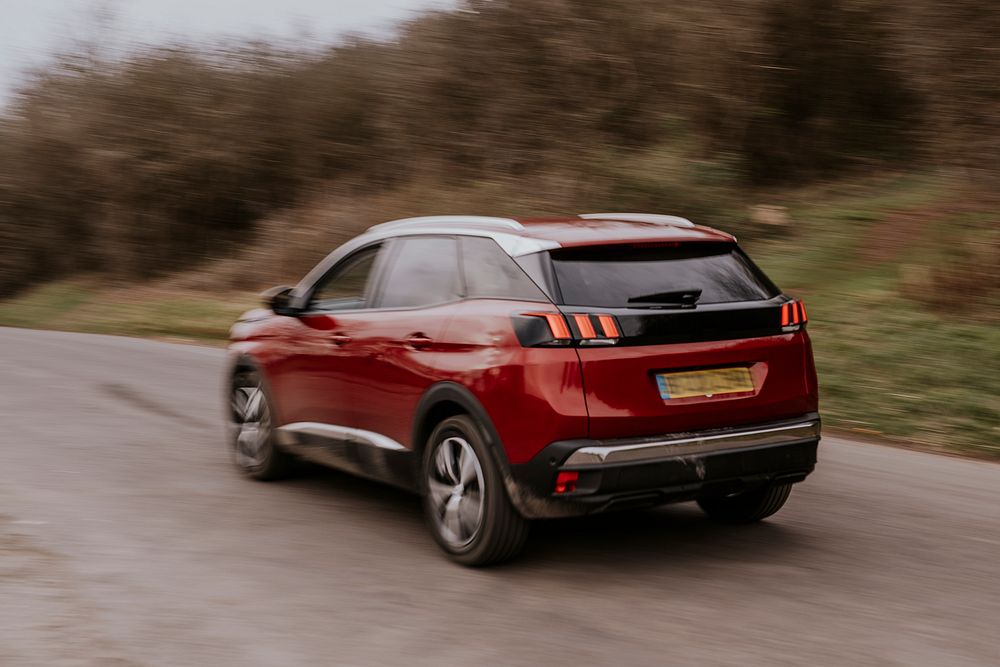 Back view of red car on hill road photo