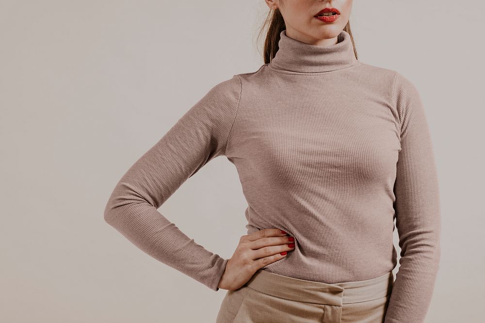 Woman wearing brown turtleneck shirt, studio shoot