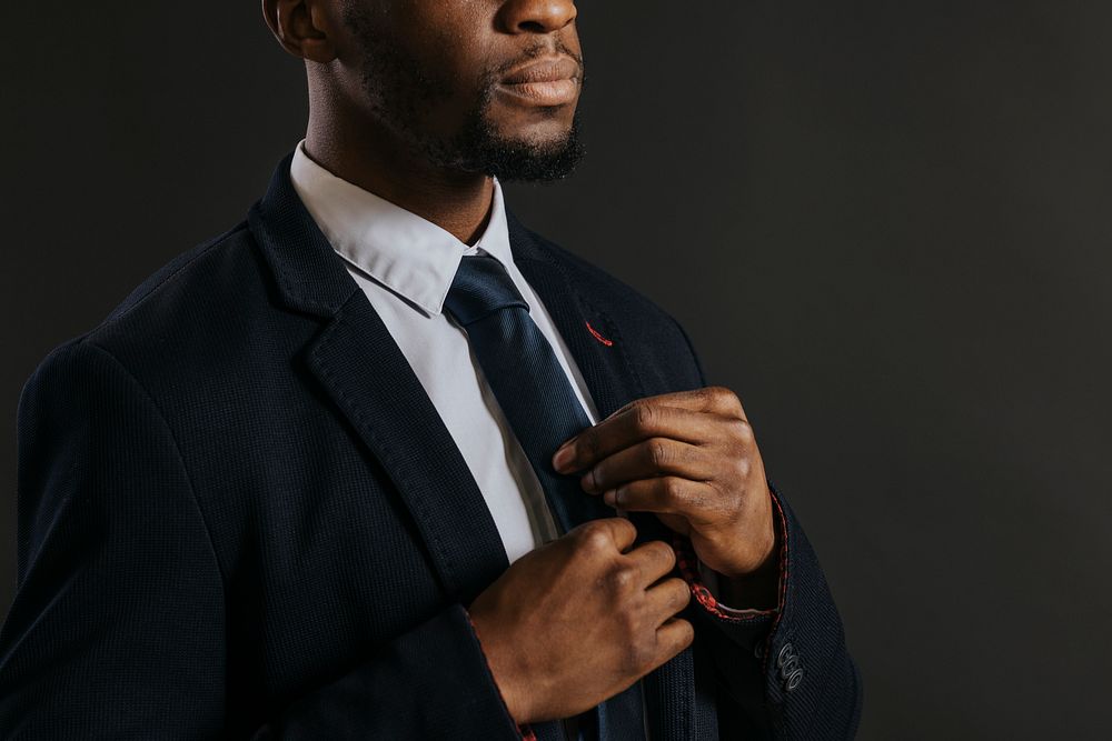 Businessman adjusting necktie, business fashion