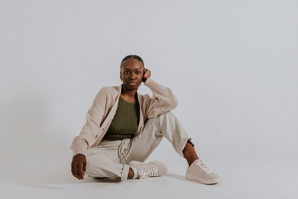 Black woman in minimal loungewear, green tank top and sweatpants