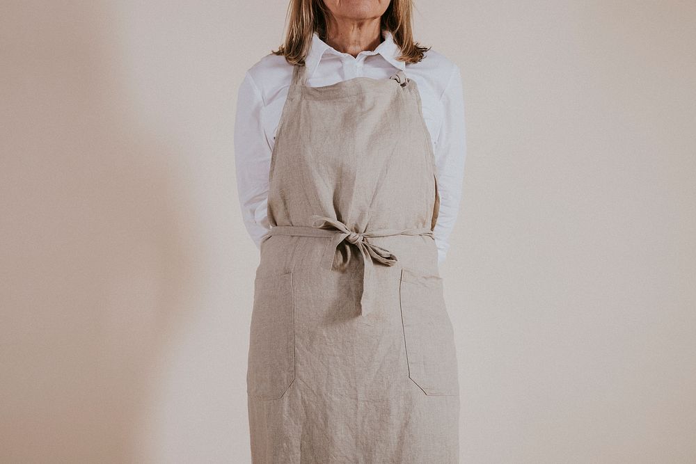 Woman wearing apron, barista job, career photo