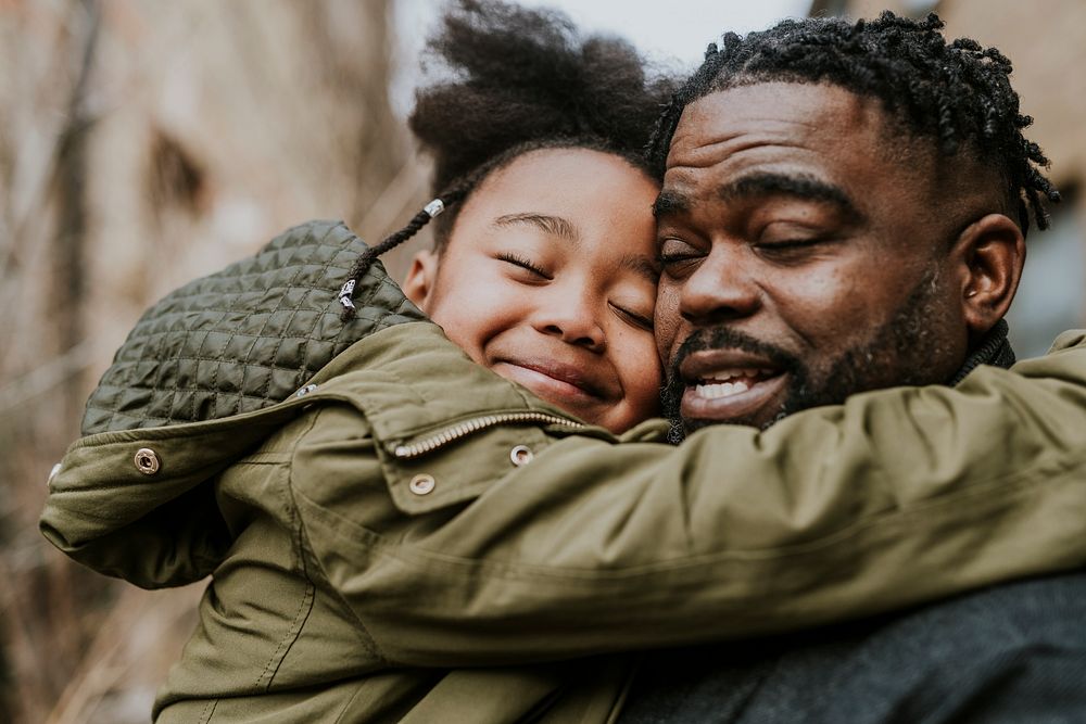 Daughter hugging her dad, African-American family photo