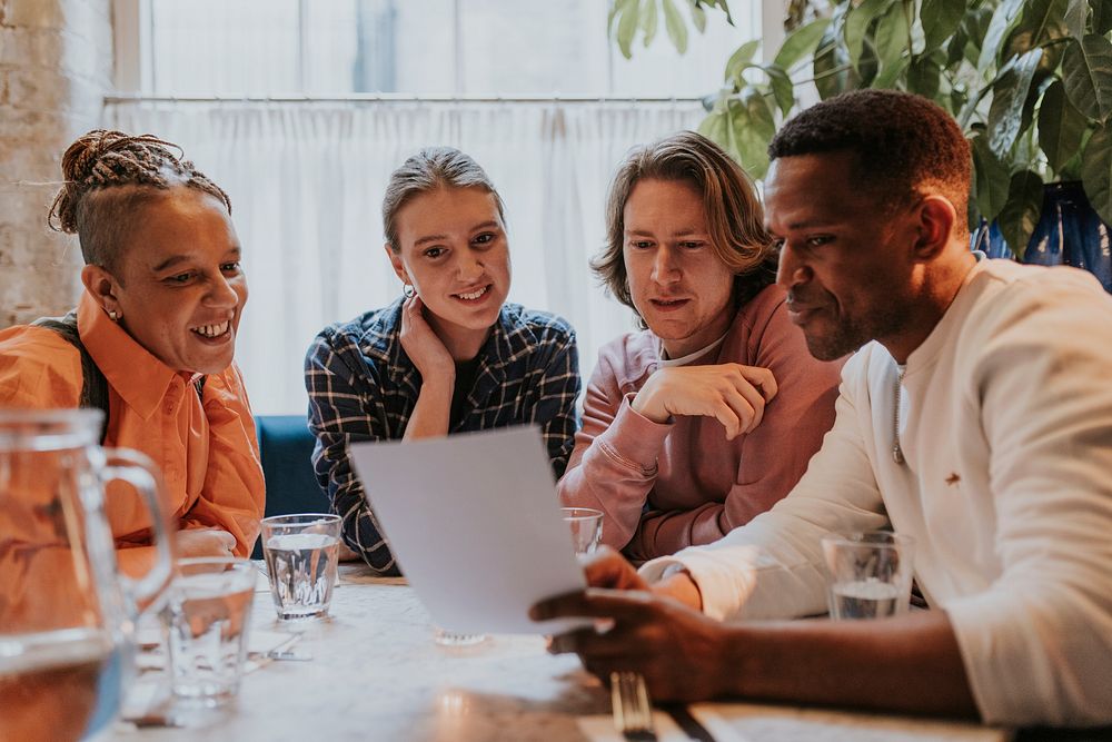 Diverse friends checking out menu at a restaurant