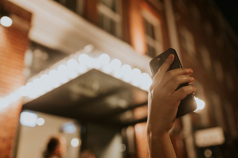 Hand holding smartphone, checking GPS