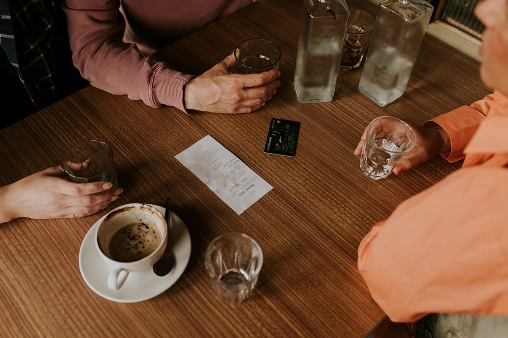 Friends splitting the bill, credit card on the  table