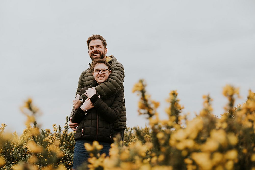 Father & daughter hugging in flower field