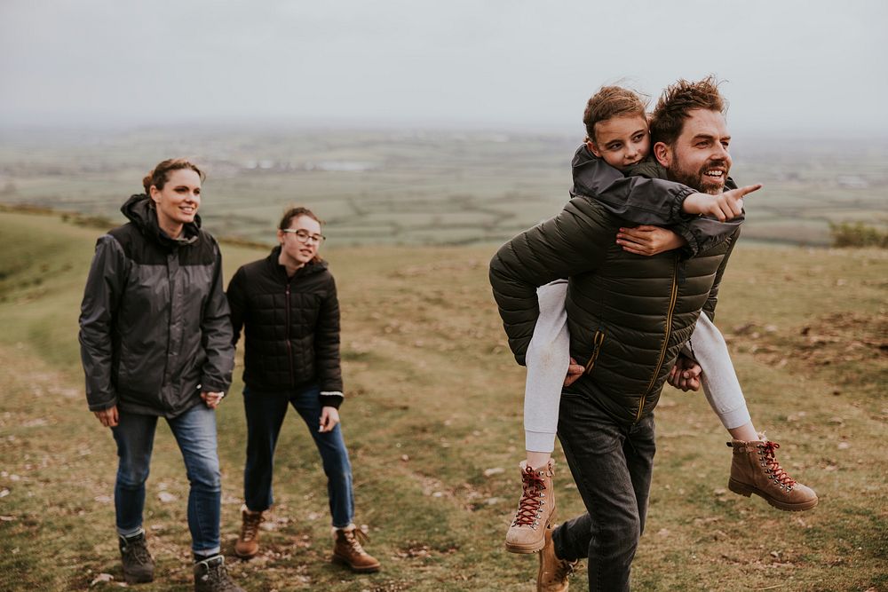 Happy family hiking on mountain, outdoor activity